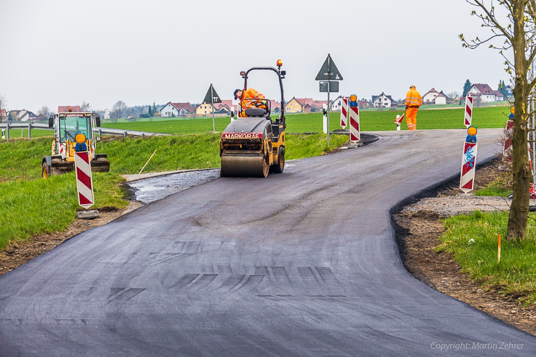 Foto: Martin Zehrer - Walzen, Teermaschine, LKWs und die Mitarbeiter der Fa. Markgraf rückten Mitte April 2015 in Zinst an, um die Ortsdurchfahrt neu zu teeren. Binnen kurzer Zeit konnten die  